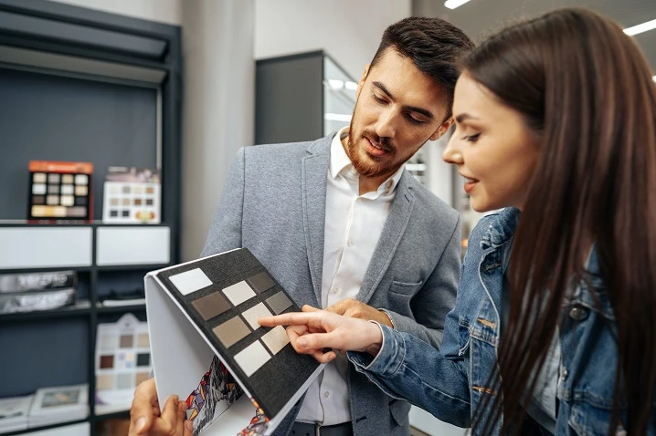 salesman-shows-color-swatches-to-lady-customer-for-new-kitchen-furniture